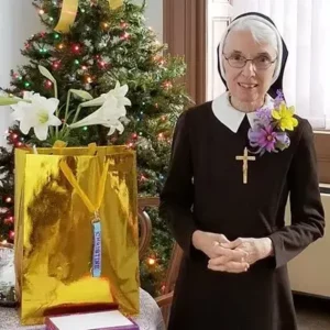 Sr. standing in front of a Christmas tree celebrates her jubilee