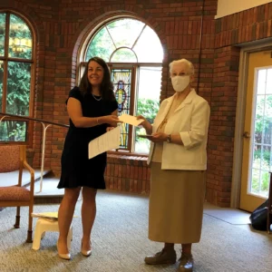 Livonia sister receives a check from Catholic Foundation of Michigan