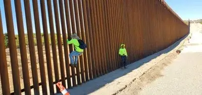 Two men near the wall at the border