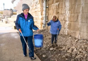 Two volunteers cleaning along the river