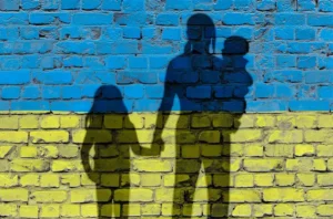 Shadows of Ukrainian family in front of a wall