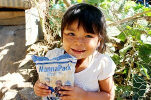 A child holds a "manna pack" nutritional meal.