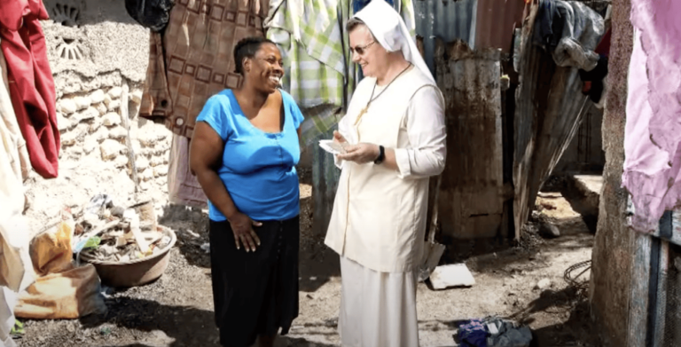 Felician Sister talking to Haitian woman.