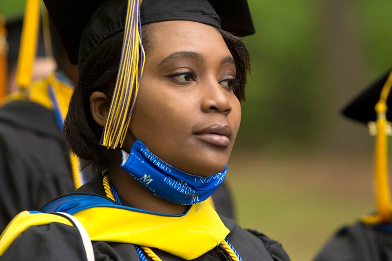 A graduate in cap & gown